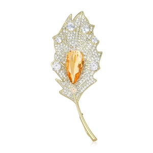 Elegant gold leaf brooch with yellow pear-cut stone and sparkling zircon pavé detail