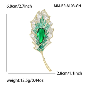 Elegant leaf brooch with white cubic zirconia and emerald green stones in gold finish
