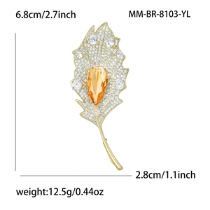 Elegant leaf brooch with pavé zircon and orange teardrop stone on gold base