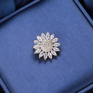 Exquisite sunflower zircon brooch with marquise-cut petals on deep blue silk background