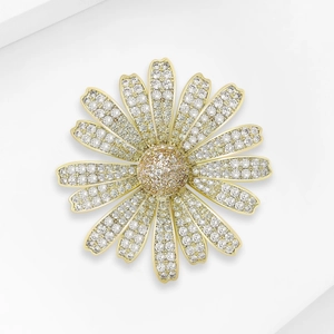 Macro shot of elegant daisy brooch with pavé-set zircons on a white geometric stand