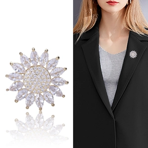 Fashionable daisy brooch with marquise stones and sparkling zircon center on a gold-plated base