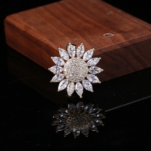 Sparkling sunflower brooch with gold setting and marquise cubic zirconia stones