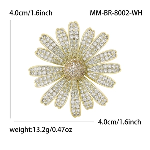 Elegant daisy flower brooch in gold with white and champagne cubic zirconia stones
