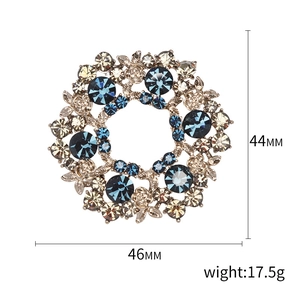 Elegant floral wreath brooch with blue and champagne crystals in a 46mm x 44mm size