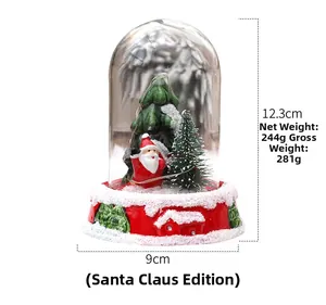 Detail of Christmas Santa miniature globe featuring a red embossed base and glass dome