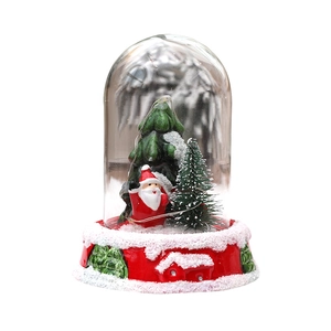 Christmas Santa Claus snow globe with LED lights in a clear glass dome and red base