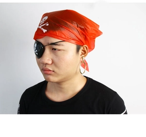 Close-up of red skull bandana, black eye patch and gold earring pirate costume accessories