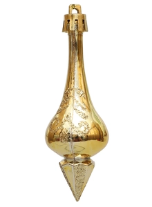 Close-up of golden teardrop Christmas pendant with glitter swirl details and pointed tip