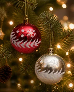 Detail of hand-painted Christmas ornaments with silver snowflake patterns and glitter
