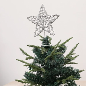 Silver glitter hollow star Christmas tree topper with spiral spring base on a tree