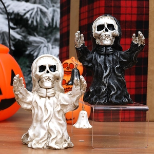 Halloween skull figurines in black and white robes holding metal bells decoration
