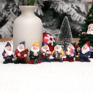 Set of seven miniature garden gnomes with colorful winter outfits and welcome sign