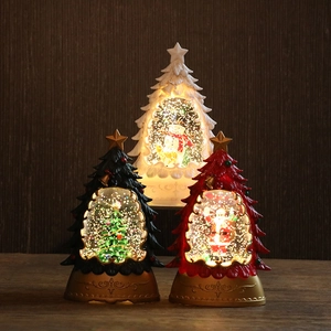 Lighted Christmas tree snow globe lanterns with Santa and snowman on vintage gold bases