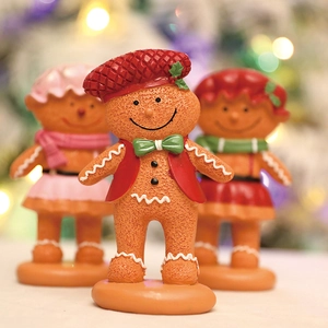 Charming gingerbread man figurines with festive red hats for Christmas home table decoration