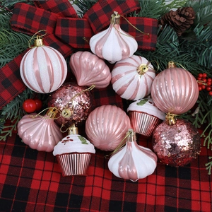 12-piece pink and white Christmas ornaments set with mixed textures on plaid background