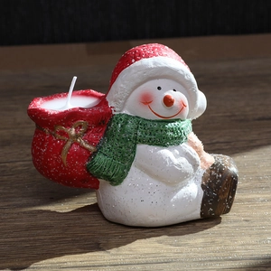 Christmas snowman candle holder with red hat and green scarf for festive dining table decor