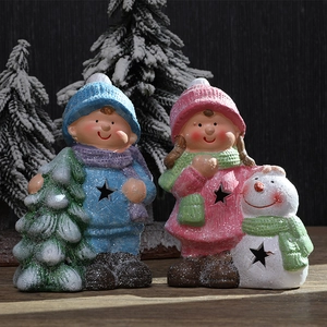 Christmas magnesium oxide boy and girl figurines with star cutouts and snowy texture