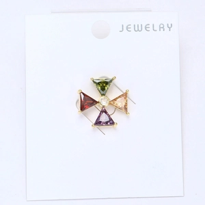 Detailed view of 18k gold plated windmill brooch with colorful sparkling zircon stones
