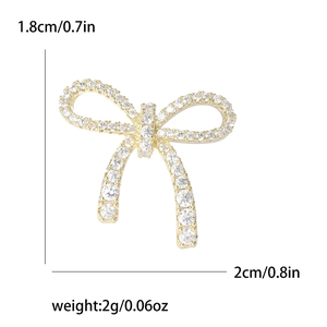 Elegant gold bow brooch with sparkling crystals measuring 1.8cm by 2cm and weighing 2g