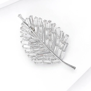 Macro detail of leaf brooch with baguette-cut cubic zirconia in silver-tone metal base