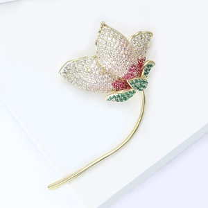 Elegant flower brooch with pink gradient zircons and green leaves on gold plating