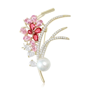 Elegant wheat ear brooch with red gemstones, paved diamonds, and a large white pearl