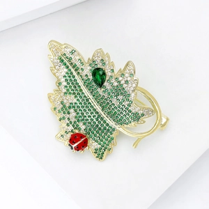 Exquisite gold maple leaf brooch with green zircon stones and a tiny red ladybug
