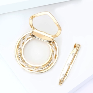 Macro view of golden silk scarf buckle with micro-inlaid zircons on a white stand