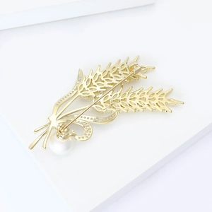 Detail view of wheat ear brooch back with secure safety clasp and gold finish