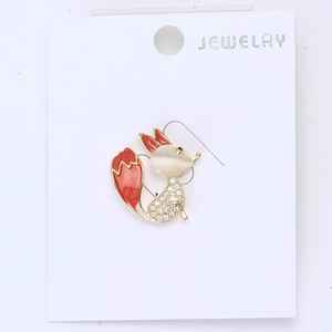 Macro shot of fox brooch featuring red enamel tail and white cubic zirconia accents
