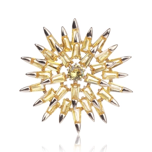Macro shot of sunburst brooch with yellow cubic zirconia and silver metal rays
