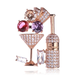 Macro detail of wine bottle brooch with micro-pave zircons and rose gold finish