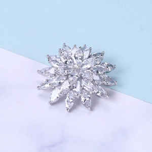 Macro detail of silver snowflake brooch with marquise cut cubic zirconia stones