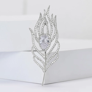 Elegant silver feather brooch with micro-pave zircons and a teardrop-shaped centerpiece
