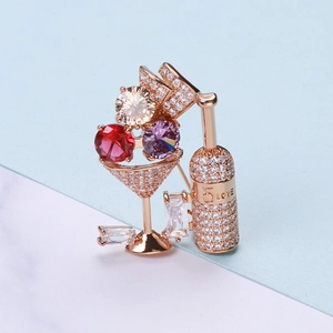 Close-up of rose gold cocktail brooch with micro-paved zircons and 5 LOVE engraving