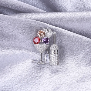 Detail of cocktail glass brooch with micro-set zircons and multicolor gemstones