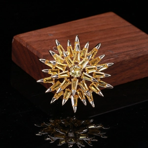 Macro shot of silver radial brooch with yellow baguette zircon on a dark wood stand