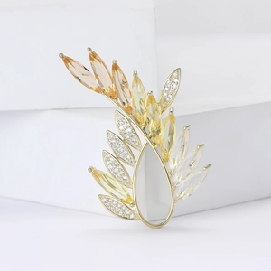 Elegant gold olive branch brooch with amber gradient stones and micro-pave crystals