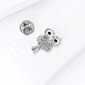 Silver owl brooch with zircon detailing showing the back closure and intricate hollow pattern