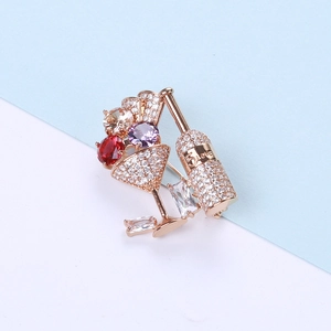 Macro detail of rose gold cocktail brooch featuring 5 LOVE engraving and micro-set zircons