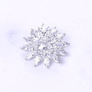Detailed view of silver snowflake brooch with marquise-cut cubic zirconia petals