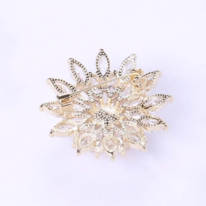Detailed back view of the golden snowflake brooch showing the secure pin fastener structure