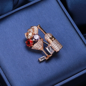 Macro detail of wine glass brooch with zircon stones in a velvet box