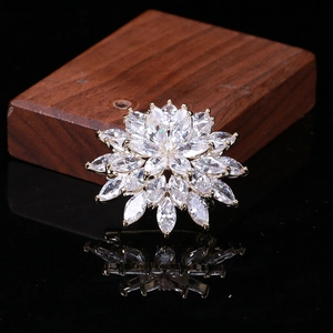 Detailed macro view of snowflake brooch with marquise-cut zircons on a silver base