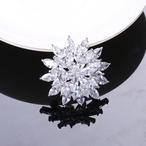 Detailed close-up of zircon snowflake brooch with marquise-cut petals on silver base