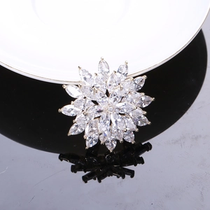 Macro shot of silver-tone snowflake brooch featuring marquise-cut marquise-cut stones