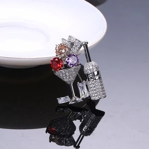 Macro shot of silver cocktail brooch with micro-pave zircons and 5 LOVE engraving