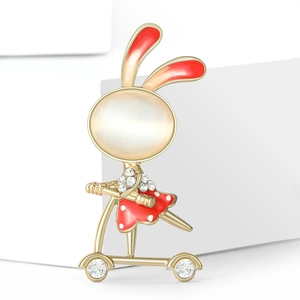 Detail of cute rabbit scooter brooch with white opal and red enamel dots