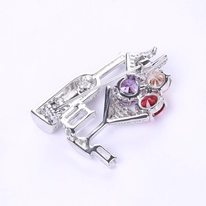 Detailed back view of cocktail brooch with silver base and secure safety pin fastener